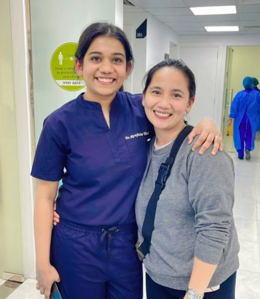 Dental professional caring for a patient inside a treatment room at Best Dental Clinic